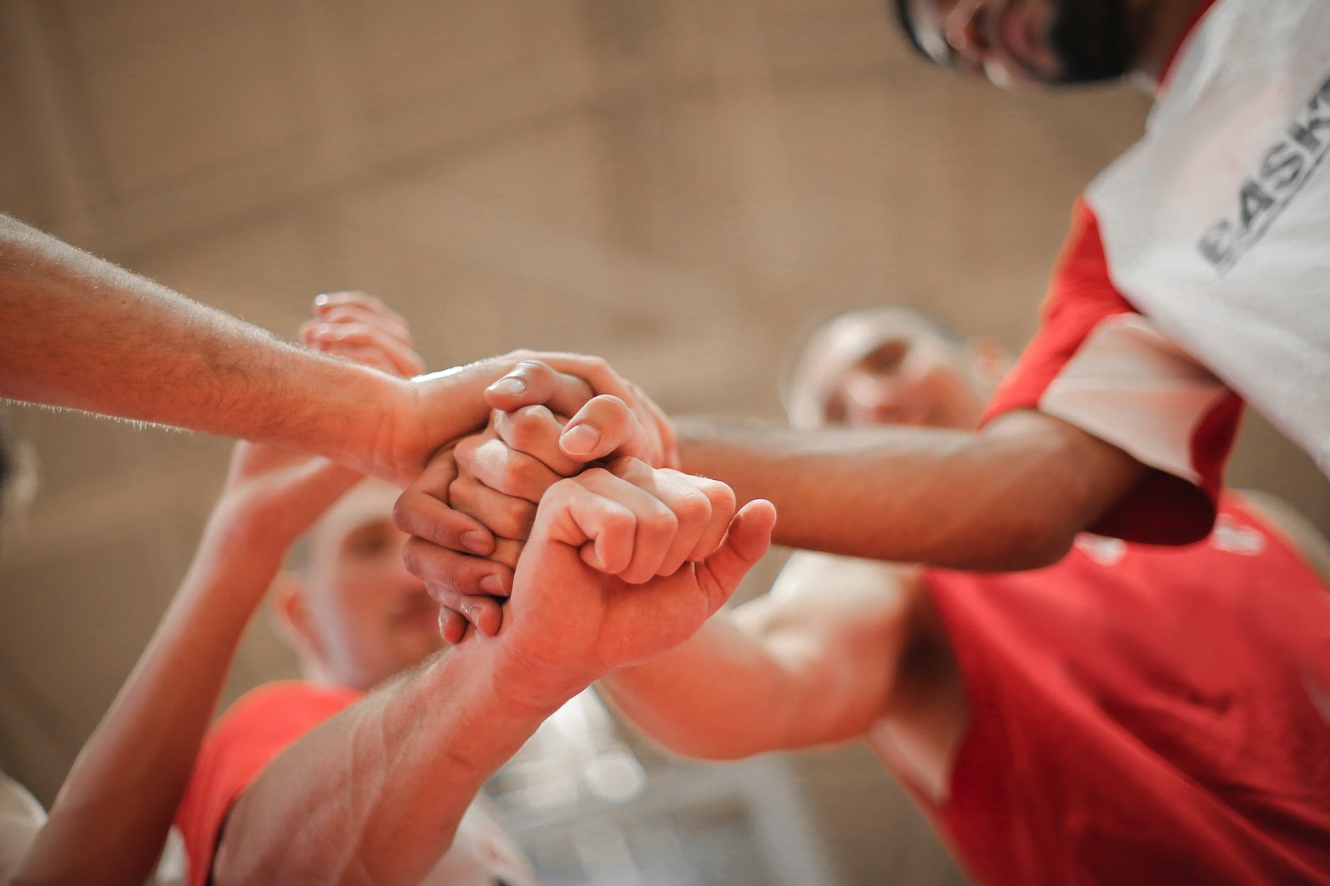 basketball team stacking hands together