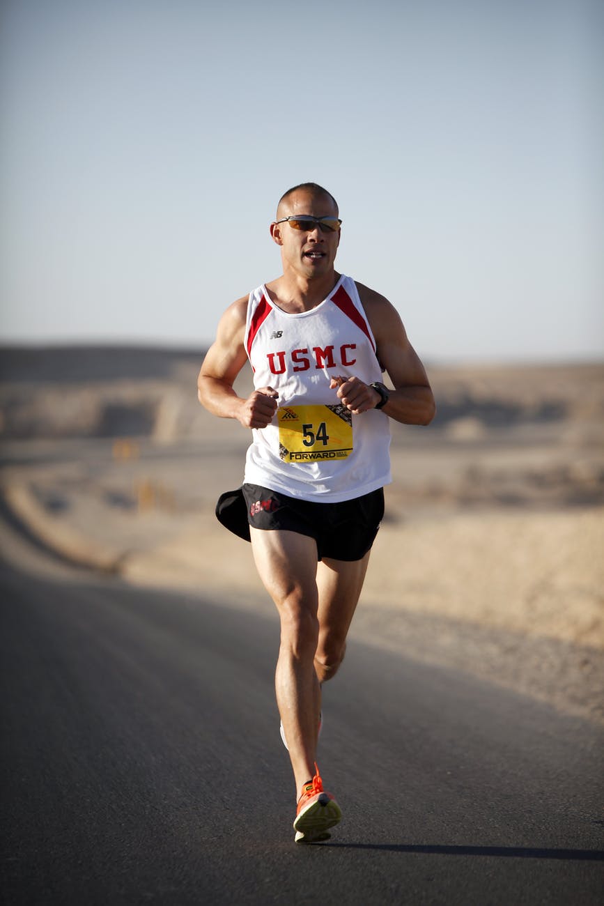 man in white jersey while running